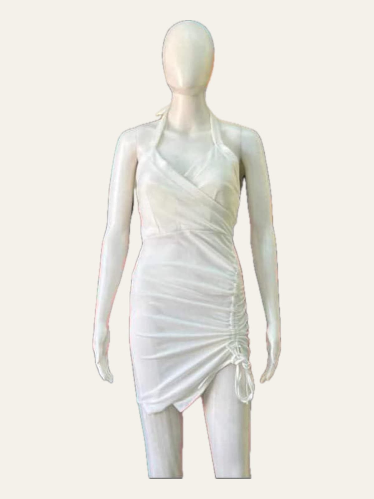 Female mannequin displaying a white draped dress